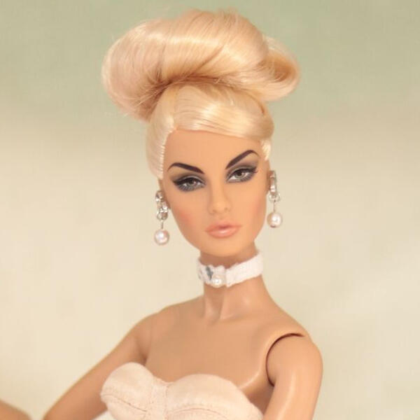 Portrait of a blonde doll named Rayna Ahmadi wearing a hairdo